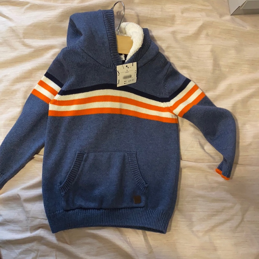 Casual toddler sweater with Sherpa lined hood.